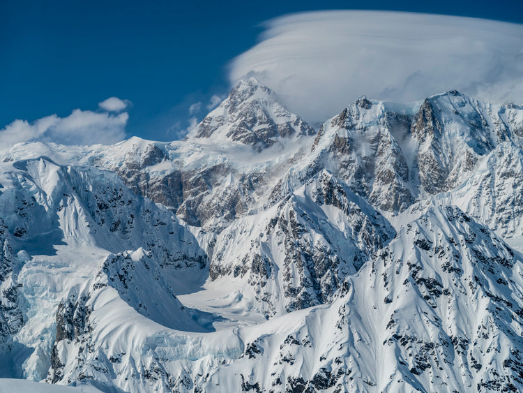 Crown of Ice: Summit Draped in Clouds