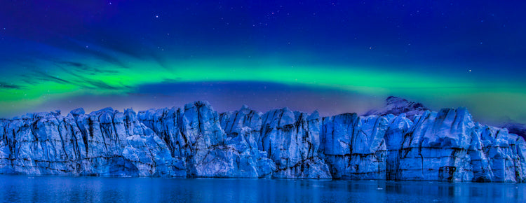 Glacial Wall Beneath an Aurora Veil