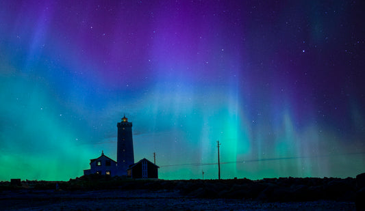 Lighthouse Beneath a Dancing Aurora