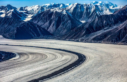 Sweeping Glacier Curve with Rugged Mountain Backdrop