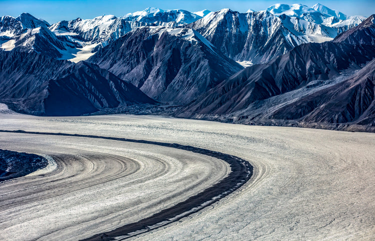 Sweeping Glacier Curve with Rugged Mountain Backdrop