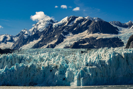 Towering Glacier Face Against Rugged Peaks